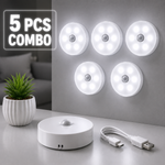 Set of five LED motion sensor lights with a control unit and USB cable on a gray surface.