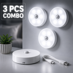 Three motion sensor night lights on a wall with a power adapter and USB cable on a surface.