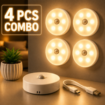 Four round LED lights with a control unit and USB cable on a surface.