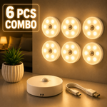 Set of six round LED lights with a power adapter and USB cable on a neutral background.