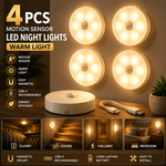 Warm white wireless stairway safety night lights illuminating steps in a modern home